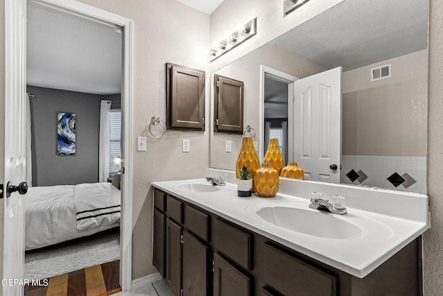 bathroom with a textured ceiling and vanity