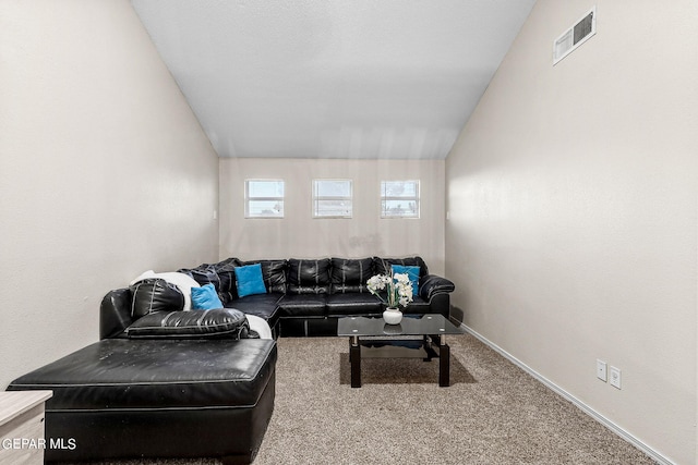 carpeted living room with lofted ceiling