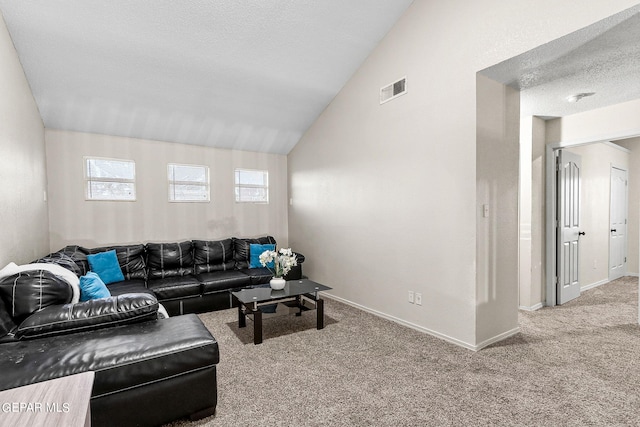 living room featuring vaulted ceiling, carpet flooring, and a textured ceiling