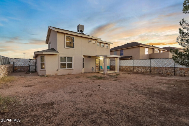 back house at dusk with central AC unit