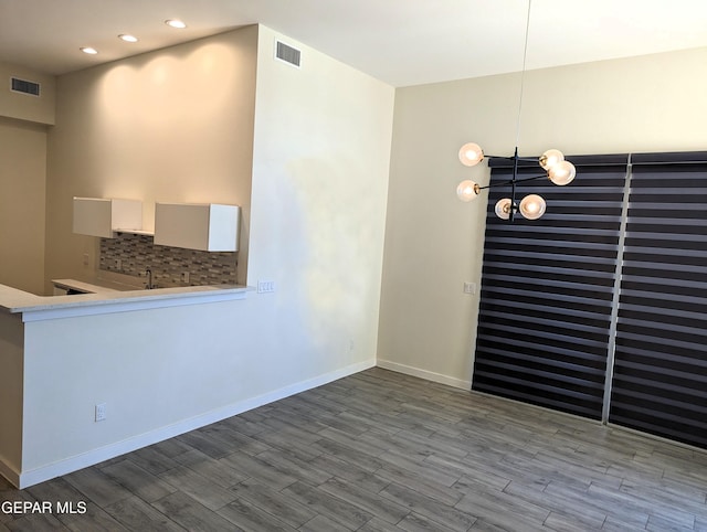 interior space featuring light hardwood / wood-style floors and a chandelier