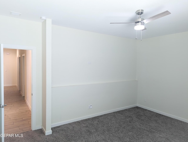 carpeted empty room featuring ceiling fan