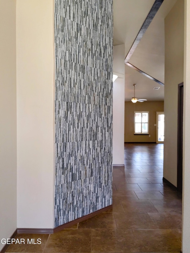 hallway featuring baseboards