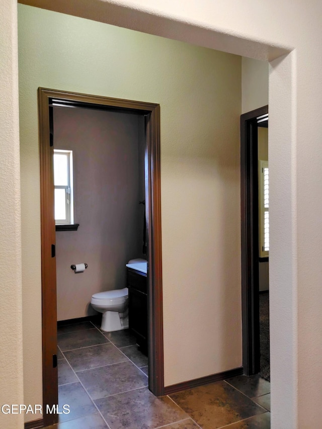 bathroom with tile patterned flooring and toilet