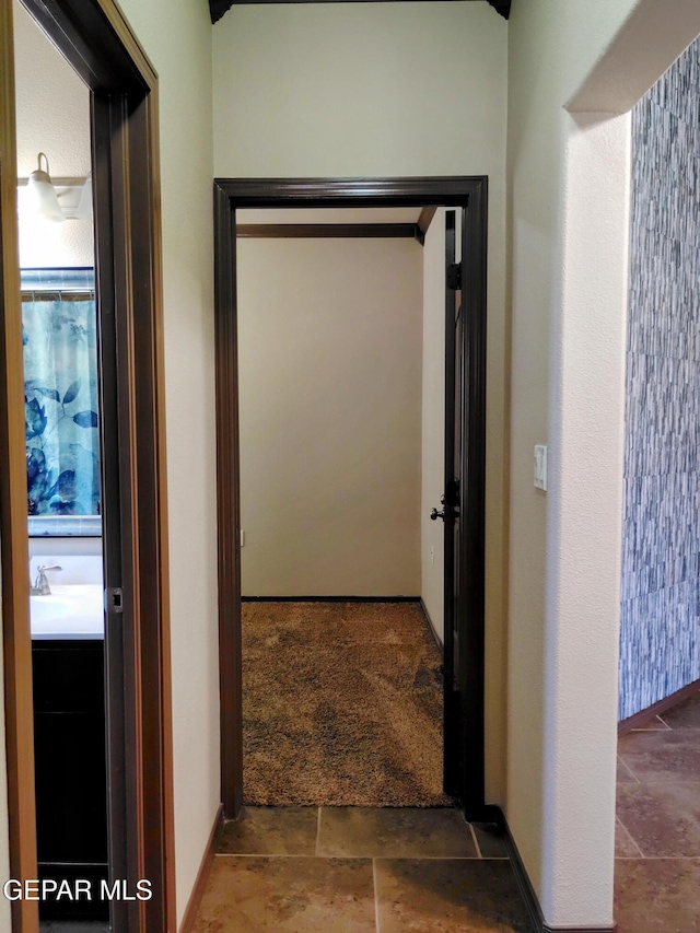 hallway featuring stone finish floor