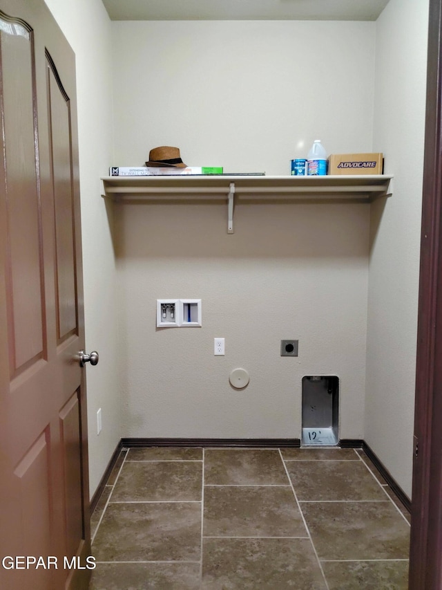 laundry area featuring laundry area, hookup for a washing machine, gas dryer hookup, tile patterned floors, and baseboards