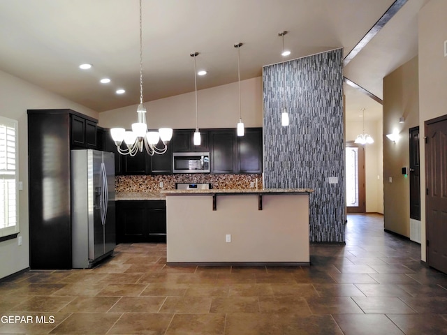 kitchen with light stone counters, plenty of natural light, a notable chandelier, stainless steel appliances, and a breakfast bar area