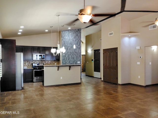 kitchen featuring ceiling fan, high vaulted ceiling, a kitchen breakfast bar, visible vents, and appliances with stainless steel finishes