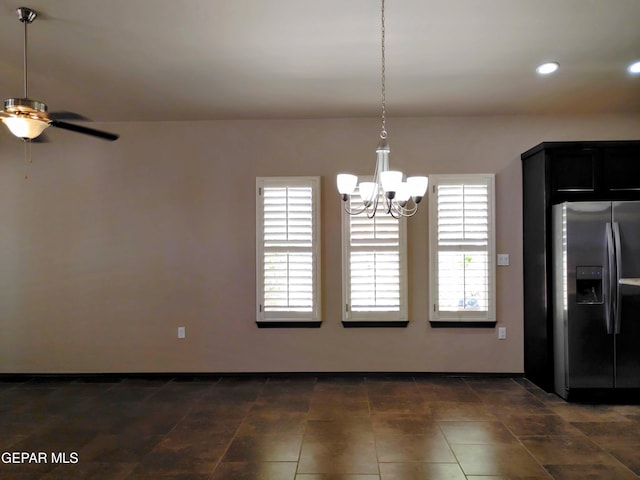 unfurnished dining area with a wealth of natural light, recessed lighting, ceiling fan with notable chandelier, and baseboards