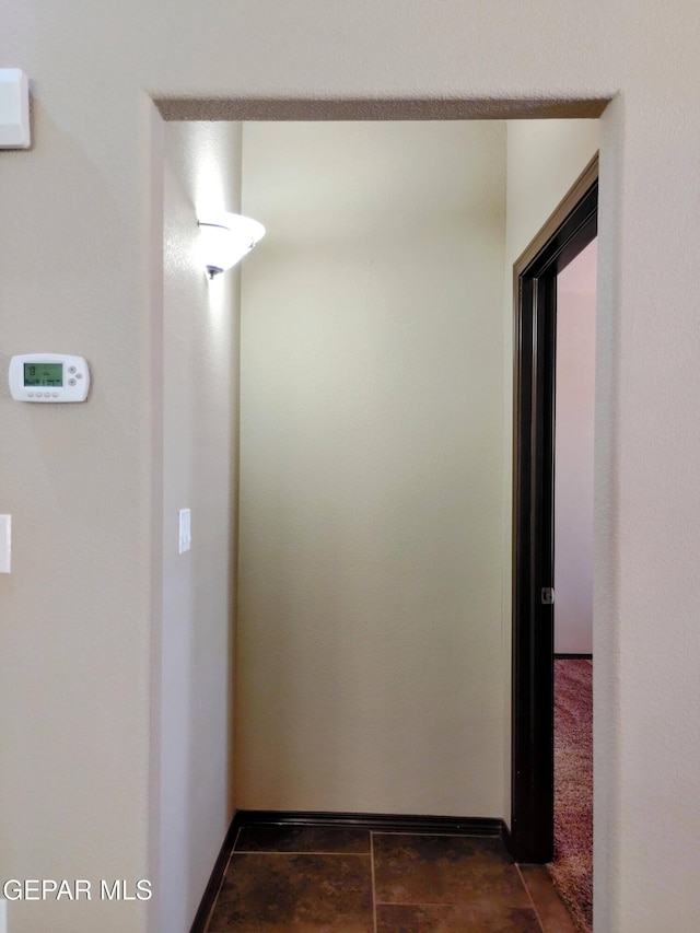 hallway featuring baseboards