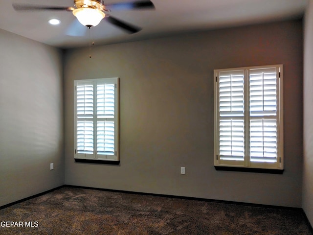 empty room with recessed lighting, baseboards, dark carpet, and a ceiling fan