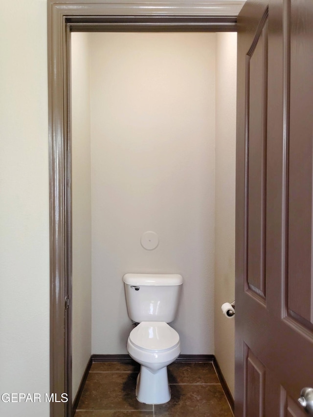bathroom featuring toilet and baseboards