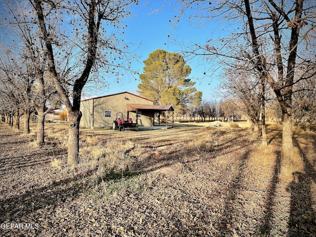 view of yard featuring a carport and a rural view