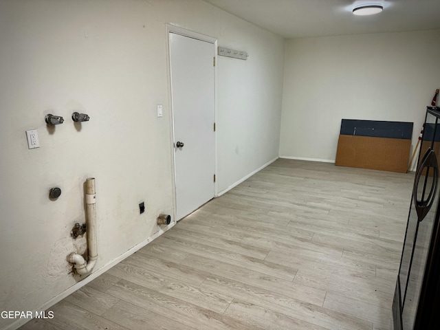 laundry room featuring electric dryer hookup, washer hookup, and light hardwood / wood-style floors