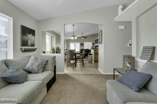 living room featuring light carpet, vaulted ceiling, and ceiling fan