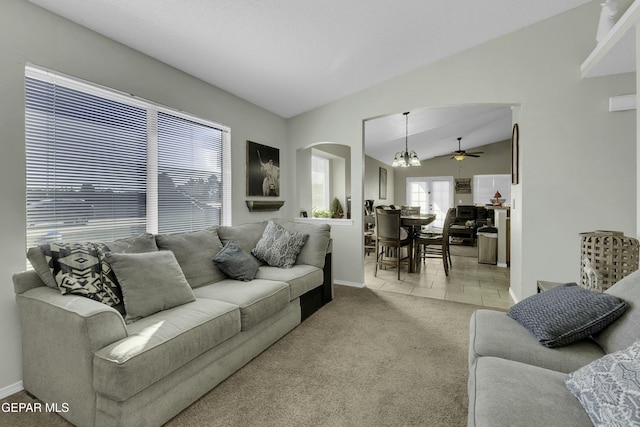 carpeted living room featuring lofted ceiling and ceiling fan