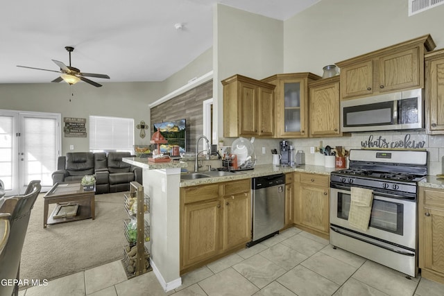 kitchen featuring stainless steel appliances, tasteful backsplash, sink, and light tile patterned floors