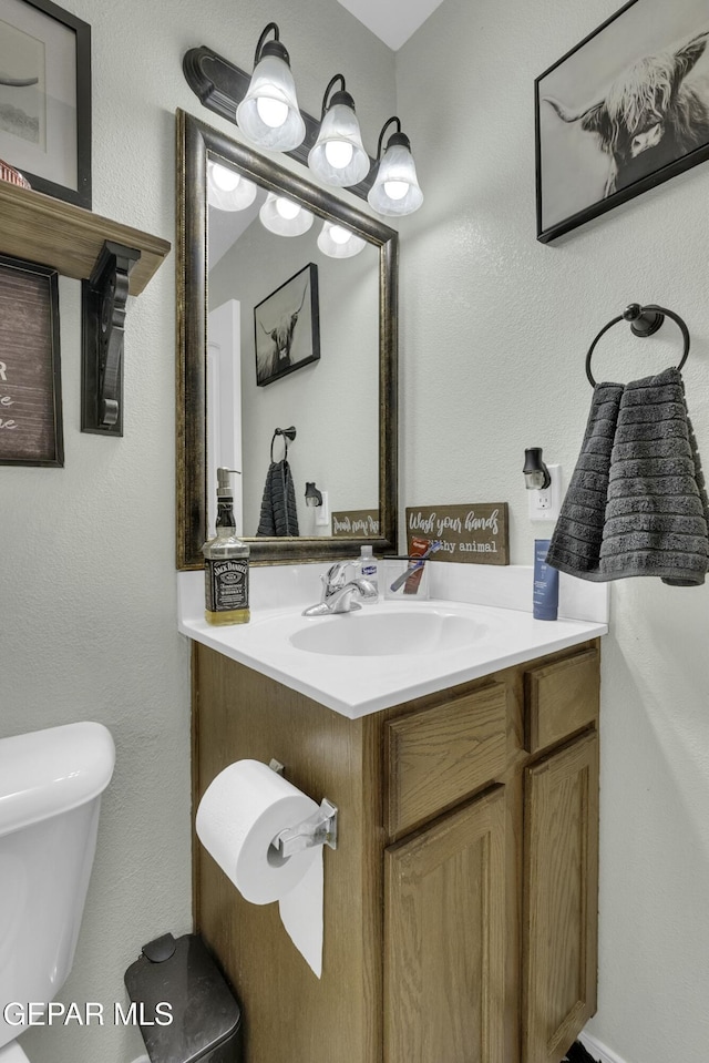 bathroom with vanity and toilet