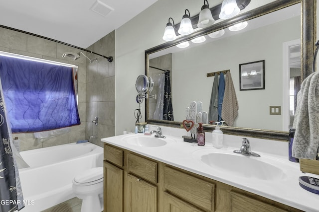 full bathroom featuring vanity, toilet, and shower / tub combo with curtain