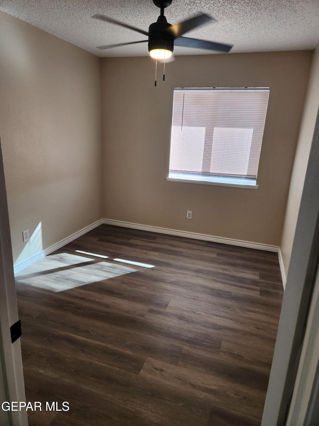 unfurnished room with dark hardwood / wood-style flooring, ceiling fan, and a textured ceiling