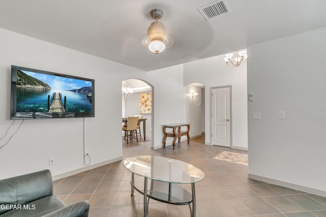 living room featuring tile patterned floors and a notable chandelier