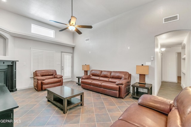 living room with high vaulted ceiling, ceiling fan, and tile patterned flooring