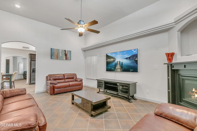 living room featuring ceiling fan and light tile patterned floors