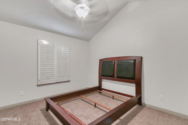 bedroom featuring ceiling fan, carpet flooring, and vaulted ceiling