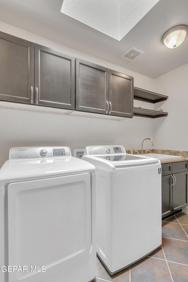 laundry room featuring sink, cabinets, tile patterned flooring, and washer and dryer