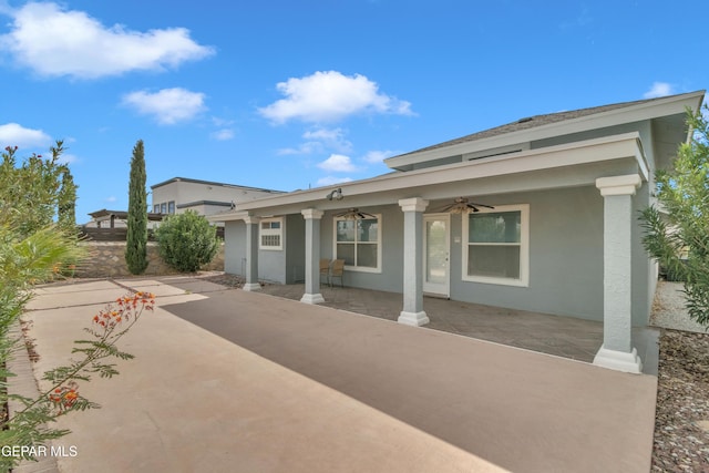 exterior space with ceiling fan and a patio