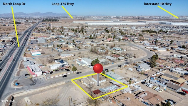 birds eye view of property with a mountain view