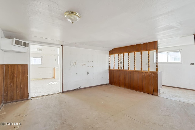 spare room featuring wood walls