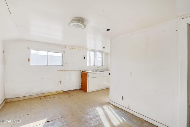 empty room featuring lofted ceiling