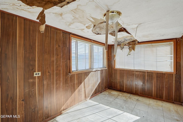 empty room featuring wooden walls