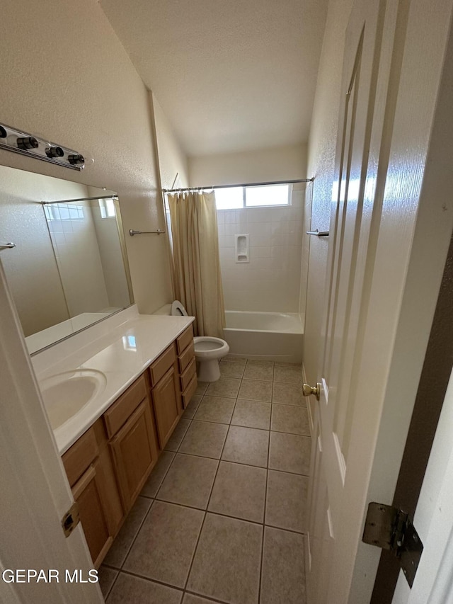 full bathroom with shower / tub combo with curtain, tile patterned flooring, vanity, and toilet