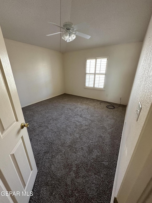 spare room featuring ceiling fan, carpet flooring, and a textured ceiling