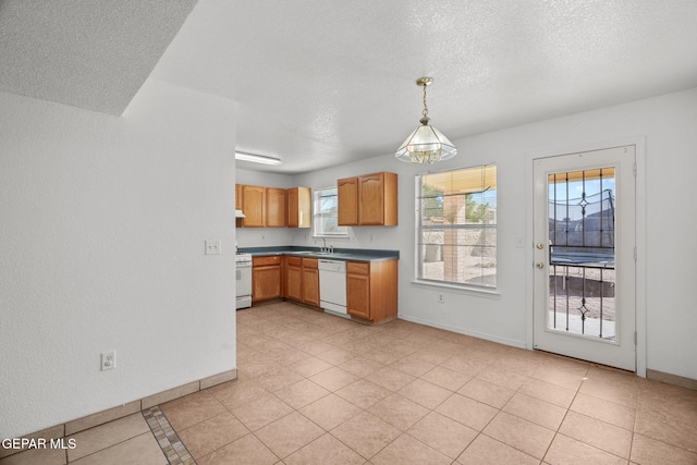 kitchen featuring plenty of natural light, pendant lighting, white appliances, and light tile patterned flooring