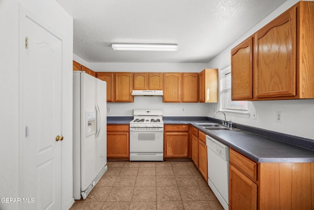 kitchen with sink, white appliances, and a textured ceiling