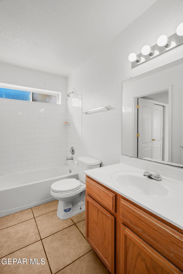 full bathroom featuring toilet, tiled shower / bath, tile patterned floors, and vanity