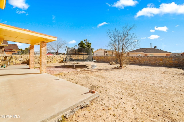 view of yard featuring a patio and a trampoline