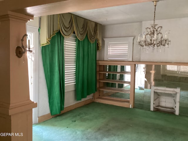 interior space with a notable chandelier and carpet flooring