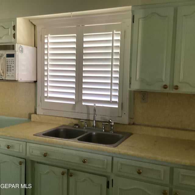 kitchen with plenty of natural light, sink, and green cabinetry