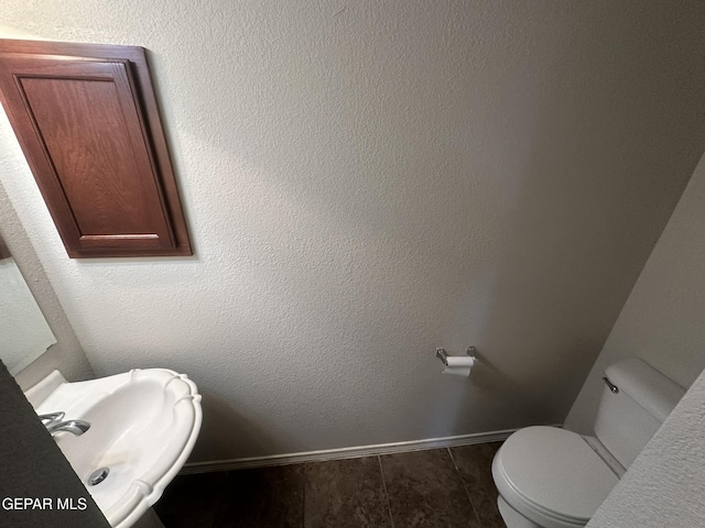 bathroom with tile patterned flooring, sink, and toilet