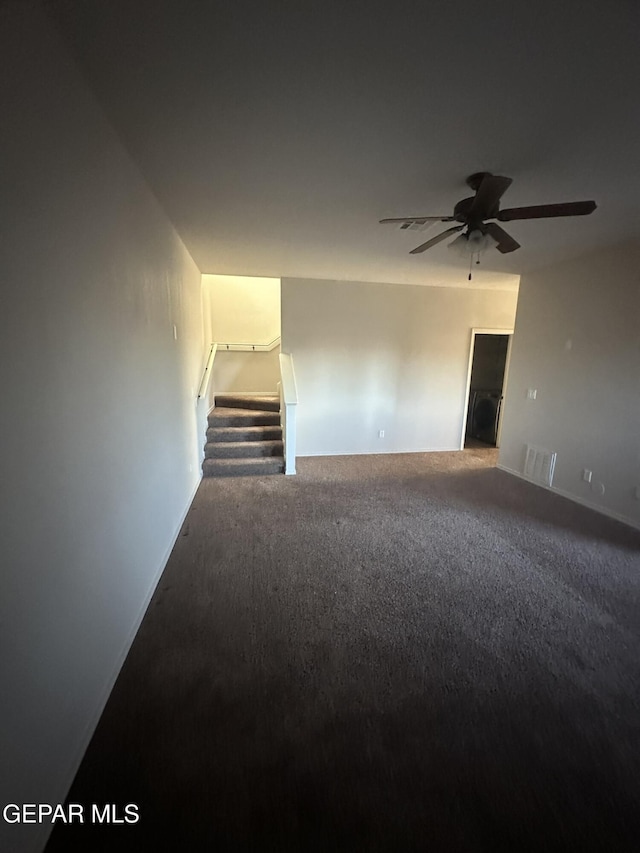 spare room with ceiling fan and carpet