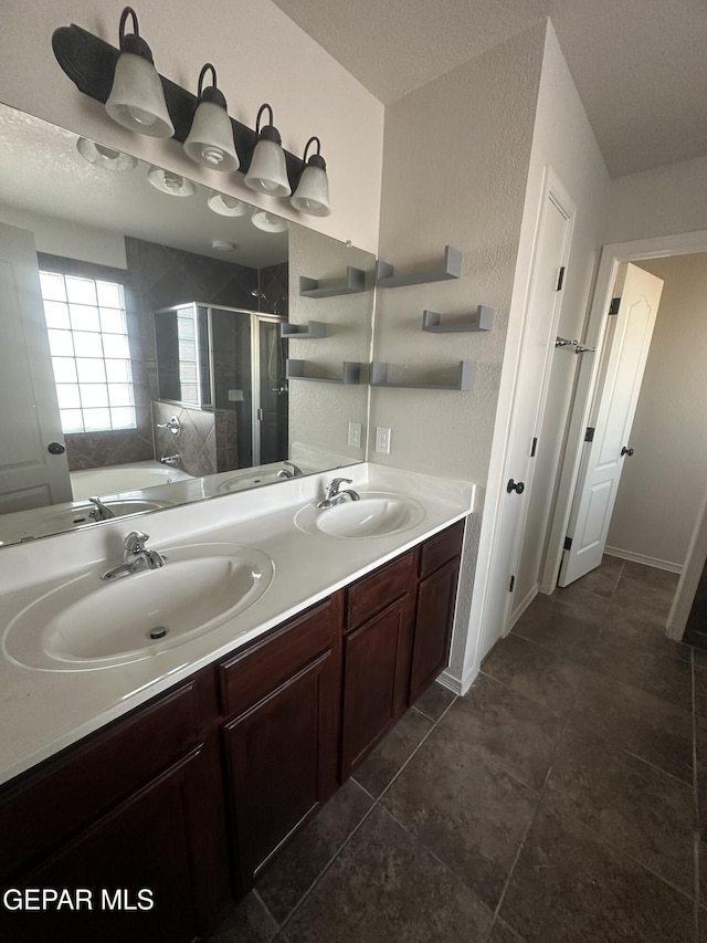 bathroom featuring vanity, a textured ceiling, and separate shower and tub