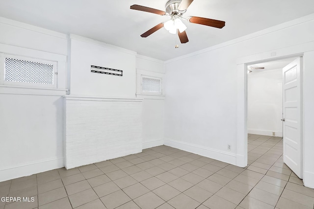 unfurnished room with ornamental molding, light tile patterned floors, and ceiling fan