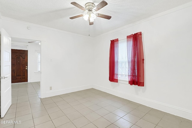 unfurnished room with ceiling fan, ornamental molding, a textured ceiling, and light tile patterned floors