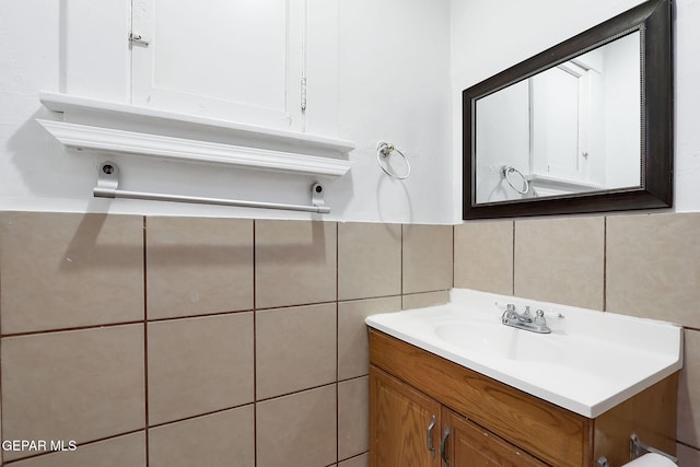 bathroom with tile walls and vanity