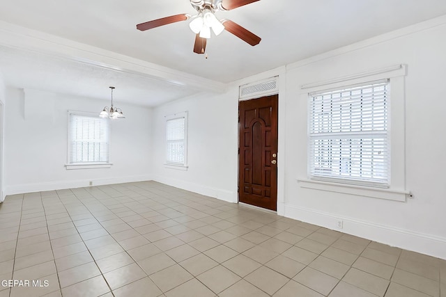 tiled foyer with beamed ceiling, a healthy amount of sunlight, and ceiling fan with notable chandelier