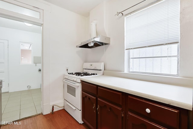 kitchen featuring light hardwood / wood-style floors and white range with gas stovetop